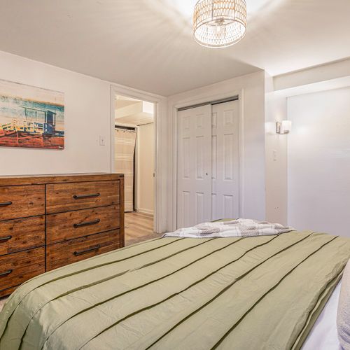 Experience the convenience of the downstairs bedroom, complete with modern decor, new light fixtures and ample storage space.