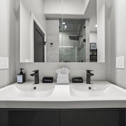 Spacious vanity area with mirror and storage for personal items.