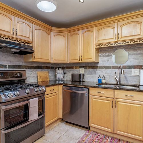 - bright and welcoming kitchen with updated lighting and a sleek undermount sink
- open shelving with decorative plants adds a cozy, homey touch
- dishwasher and elegant finishes ensure a comfortable and effortless cooking experience