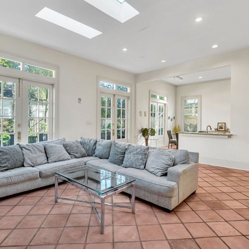 Spacious living room with natural light and cozy seating.