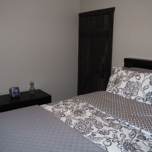 Bedroom #2 (main floor):  features a queen-size bed, ceiling fan, dresser, and closet.