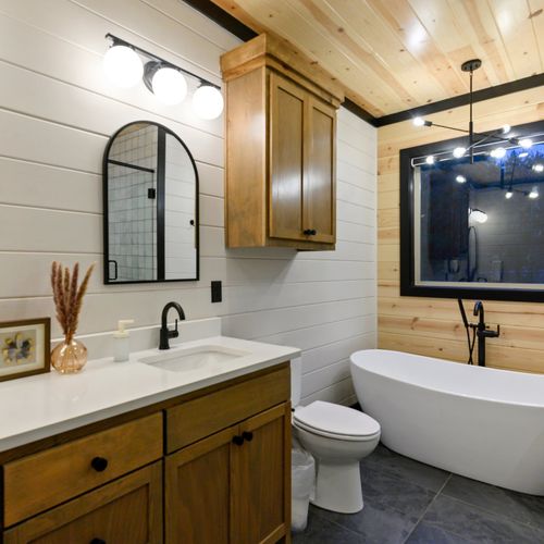 This bathroom features a double vanity and soaking tub.