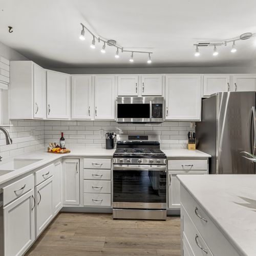 Whip up your favorite dishes in the sleek modern kitchen, outfitted with stainless steel appliances, plenty of counter space, and excellent lighting.