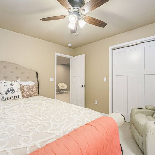 Second bedroom furnished with a soft queen bed and cozy bedding. There is ample closet space for your wardrobe and belongings.