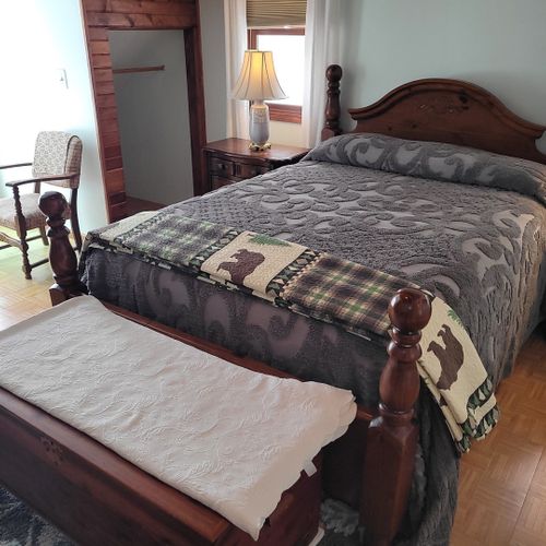 Bedroom #2 (second floor):  very large bedroom features a queen-size bed, walk-out deck, chair, 2 nightstands, 2 lamps, 2 dressers, ceiling fan, television, and private en suite full bathroom