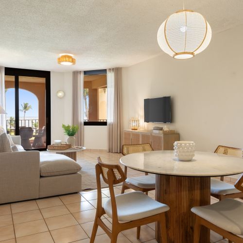 Unwind in our stylish and spacious living room, featuring a comfortable sectional and chic coastal decor.
