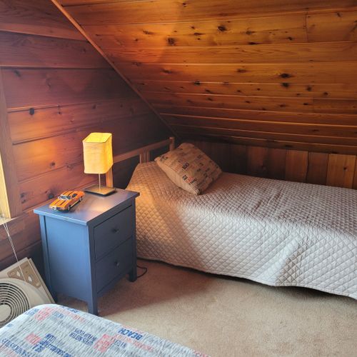 Bedroom #4 (larger hosue, second floor):  this is a large private area with its own sectional sofa, television, desk, and two twin beds.