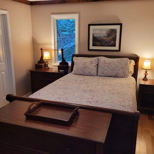 BEDROOM #1 (SECOND FLOOR):  Features a queen-size bed, nightstands, lamps, dresser, mirror, 2 closets, and its own private entrance to the bathroom on the second floor.