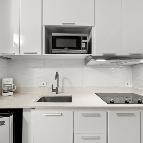 Compact yet complete kitchen with ample storage, ensuring a hassle-free cooking experience.