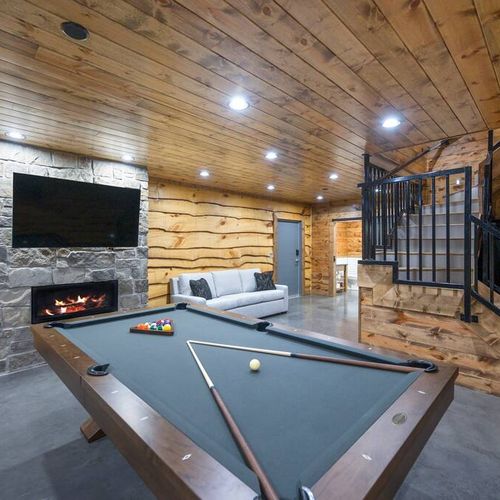 The game room with a pool table and fireplace!