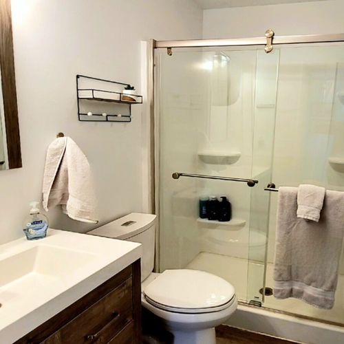 Full-bath:  the cottage has a lovely full bathroom with a shower, sink, vanity, mirror, and toilet.
