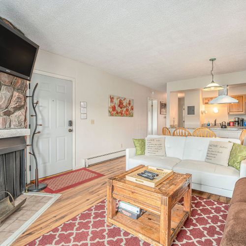 Enjoy mountain sunsets from the couch—fireplace, tv, and soft lighting set the mood.