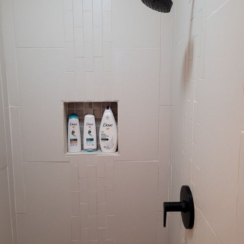 Bathroom #2:  second full bathroom that also serves as the laundry room having a stacked washer and dryer in it.