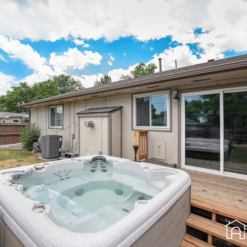 The spacious fenced-in backyard is yours to enjoy, featuring the high-end hot tub, perfect for unwinding.