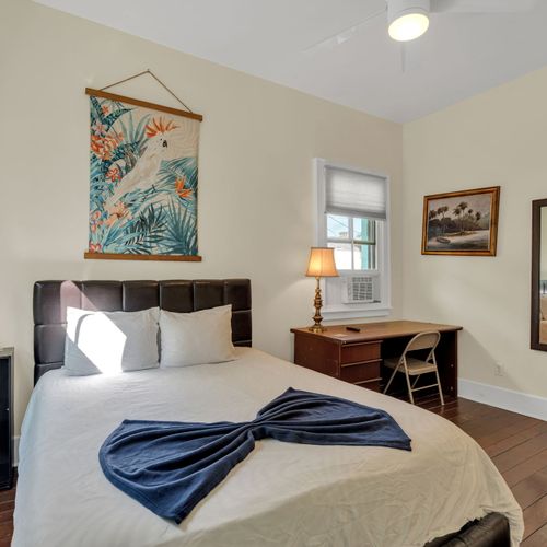 Cozy bedroom w/ a plush bed, local artwork & a quiet, restful atmosphere.