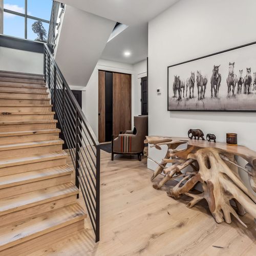 Wooden stair rail meets chic, contemporary decor in this stylish mountain home.