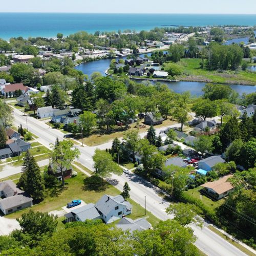 Exterior:  looking southeast with the house in the foreground and the au sable river, downtown oscoda, and lake huron in the background.