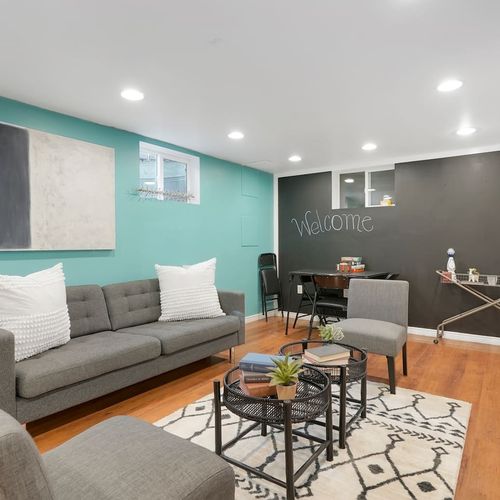 - cozy lower level lounge with teal and chalkboard walls for added personality
- comfortable seating, modern rug, and soft lighting create an inviting vibe
- great for group games, casual chats, or relaxing with your favorite shows