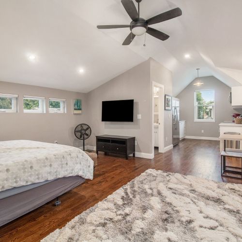 Inside feels fresh with white walls, tall ceilings, and natural light pouring in. The loft style makes it easy to move around, relax and make it your own.