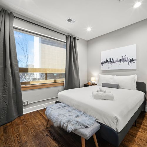 Secondary bedroom features blackout curtains and a comfortable plush mattress.