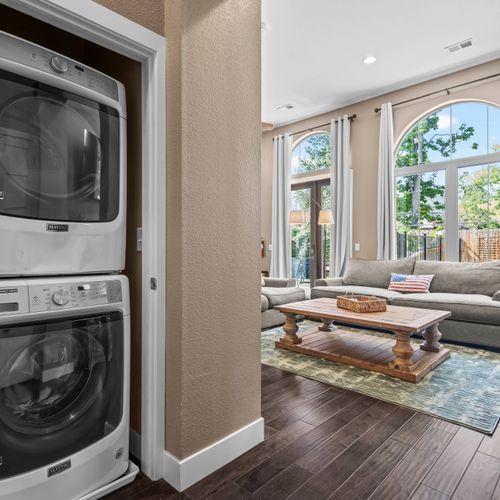 Laundry room conveniently located near the living room.