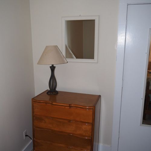 Bedroom #2:  features two twin beds, a nightstand, lamp, dresser, mirror, and closet.