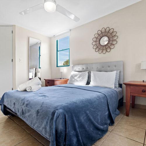A beautiful, sunlit room with a comfy bed and plenty of storage space.
