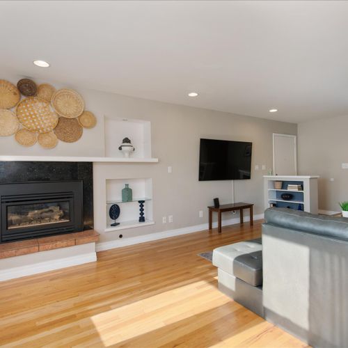 The large living room windows provide open neighborhood views and plenty of natural light.