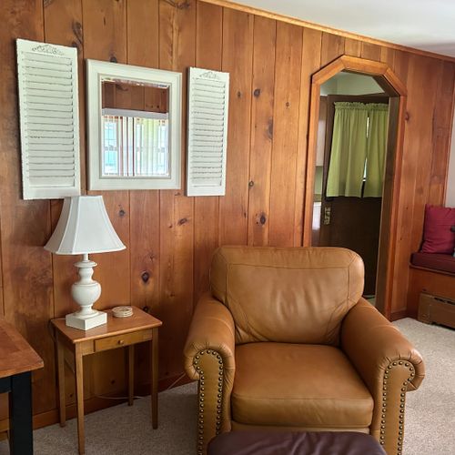 Living room: the cabin has a very cozy living room with a sofa, loveseat, comfy chair, and live streaming television.