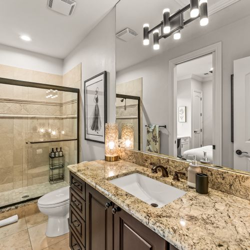 Room to refresh—spacious vanity, sleek surfaces, and soft lighting.