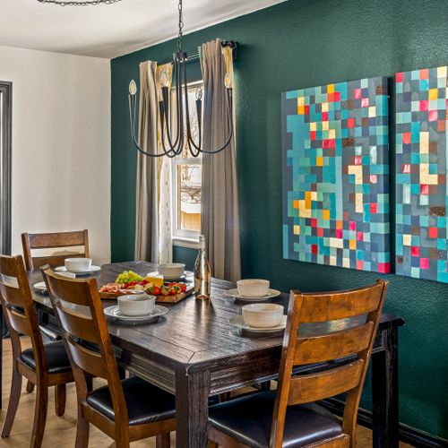 The dining area features deep green hues and sophisticated details for a refined experience.