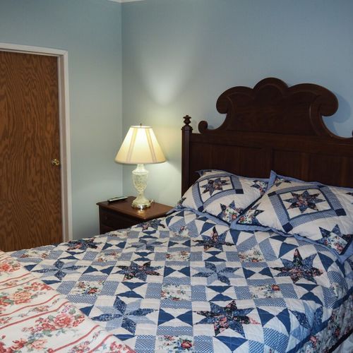 Bedroom #1 (master bedroom):  this bedroom features a queen-size bed, its own television (with cable), two dressers, a chair, a nightstand, a lamp, a very large closet, and its own en suite bathroom (behind the door shown in the photo).