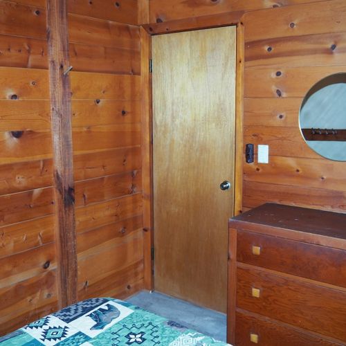 Bedroom #1:  features a full-size bed, chair, dresser, closet, and mirror.