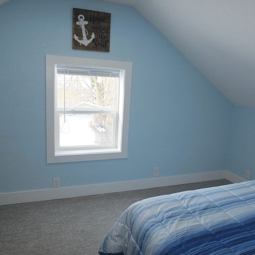 Bedroom #2 (upstairs):  the far end of the bedroom, highlighting the window that looks out into the side yard facing the west.