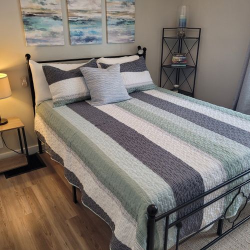 Bedroom #2:  features a queen-size bed, ceiling fan, nightstand, lamp, large closet, and 2 chairs.