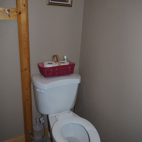 Bathroom:  features a shower and a toilet. (note that there is no vanity, sink, or mirror in the bathroom. )