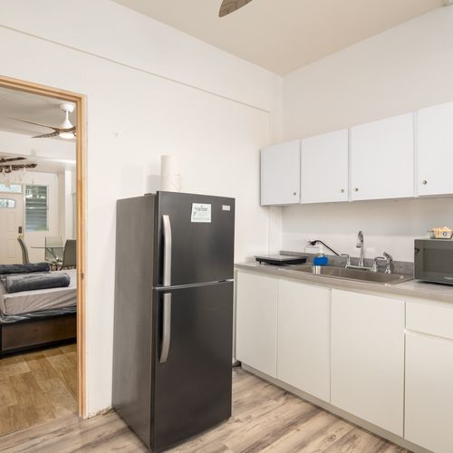 Full-size fridge and ample kitchen storage.