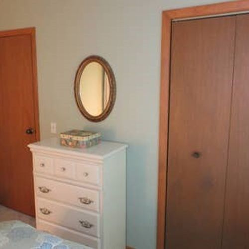 Bedroom #2: features a full-size bed, chair, nightstand, lamp, dresser, and closet.