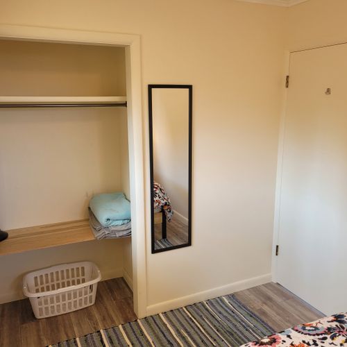 Bedroom #1:  features a queen-size bed, nightstands, lamps, mirror, and closet.