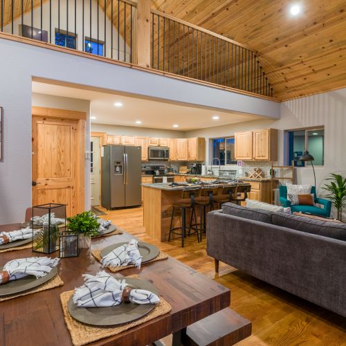 The dining area provides a glimpse of the living room, where a mod-farmhouse table seats up to six.