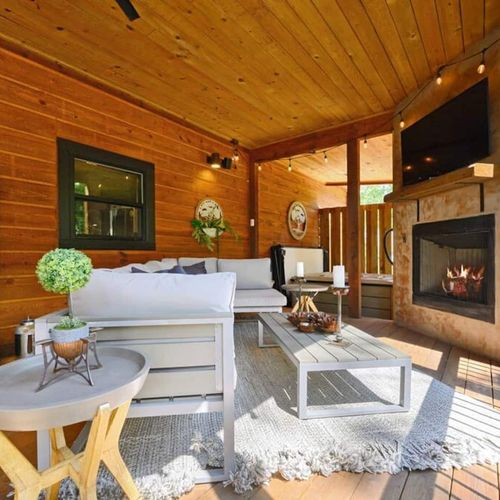 The bottom covered patio features an oversized outdoor sectional + fireplace.