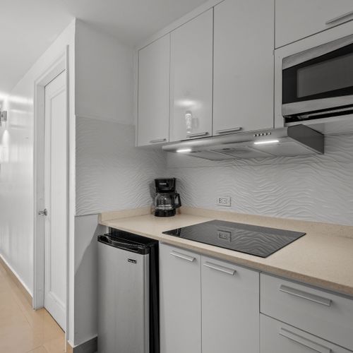 This stylish kitchen offers a contemporary design with practical amenities, making meal prep a breeze. The clean lines and bright finishes create an inviting space.