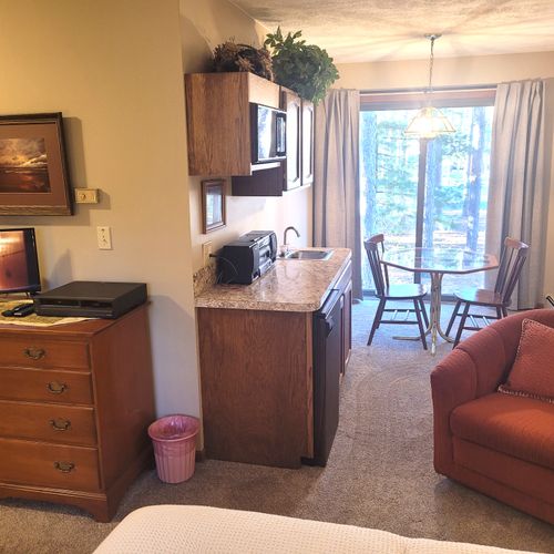 BEDROOM #1 (MAIN FLOOR):  Huge primary bedroom on the main floor with private ensuite bathroom and its own television, kitchenette, and dining table!