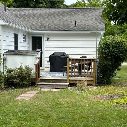 Exterior:  a closer shot of the backyard deck, which features a gas grill and outdoor dining furniture