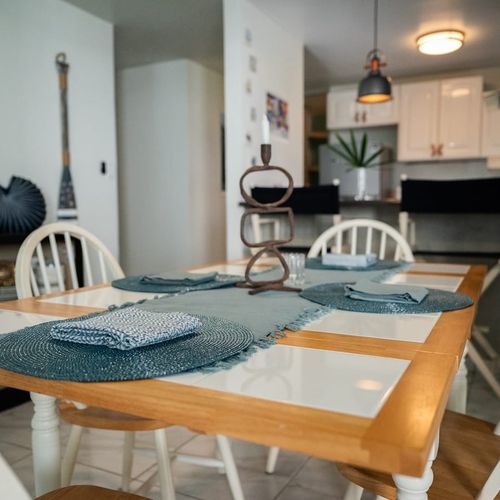 Gather and enjoy meals in our charming dining area, beautifully set for delightful conversations.