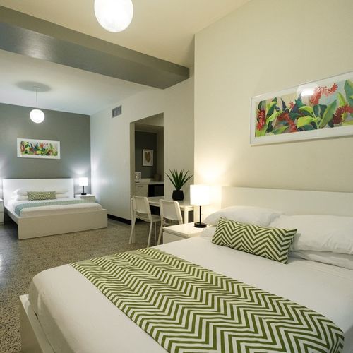 Immerse yourself in a relaxing atmosphere within this stylish bedroom, adorned with subtle artistic touches that create a unique and inviting space.