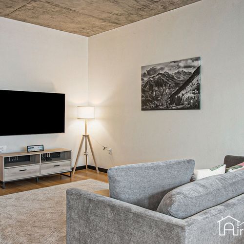 - unwind in a cozy media space with a plush sofa, modern tv stand, and floor lamp glow
- neutral tones and cityscape artwork add calming touches to the minimalist vibe
- perfect for movie nights, reading, or relaxing after exploring the city