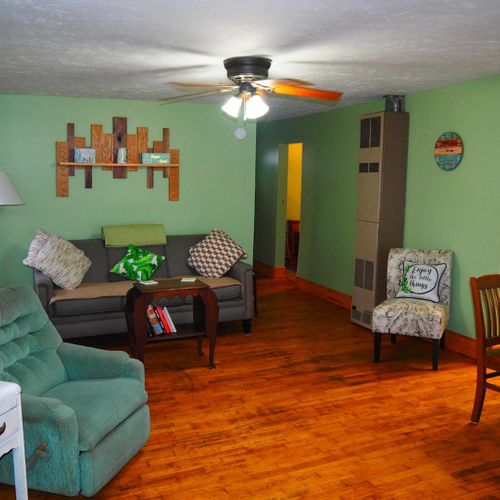 Living room and dining area:  very cute and cozy living room and dining area with a sofa, comfy chairs, dining table and chairs for 4 adults, ceiling fan, television with satellite tv, and a great view of turk lake!