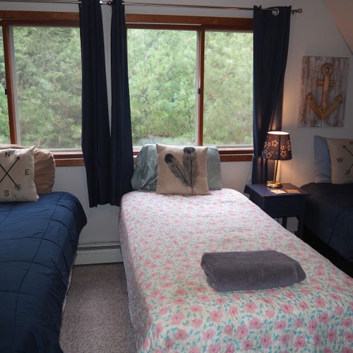 Bedroom #4 (second floor):  features 3 twin-size beds, nightstands with lamps, ceiling fan, closet, dresser, chair, and its own private television.