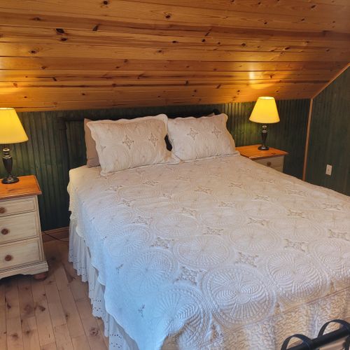 Bedroom #2 (upper level):  features a queen-size bed, chair, dresser, closet, ceiling fan, nightstands, and lamp